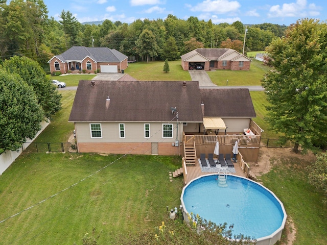 view of swimming pool featuring a deck and a lawn