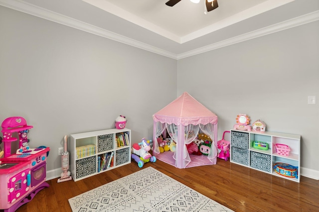 playroom featuring ceiling fan, wood-type flooring, and ornamental molding