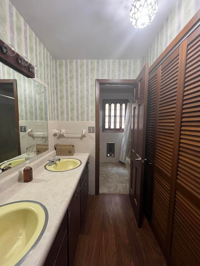 bathroom featuring tile walls, wood-type flooring, and vanity