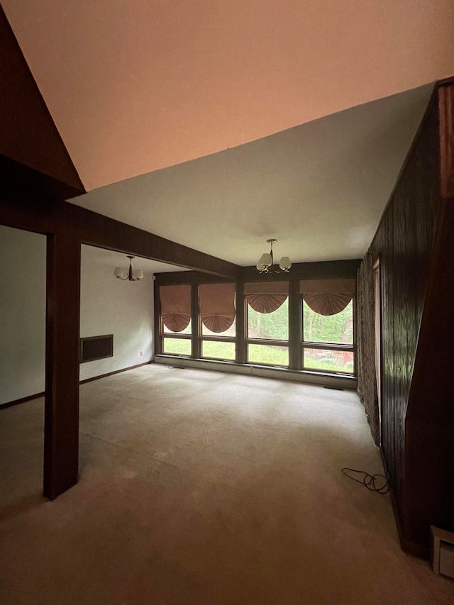 interior space with lofted ceiling, an inviting chandelier, and light carpet