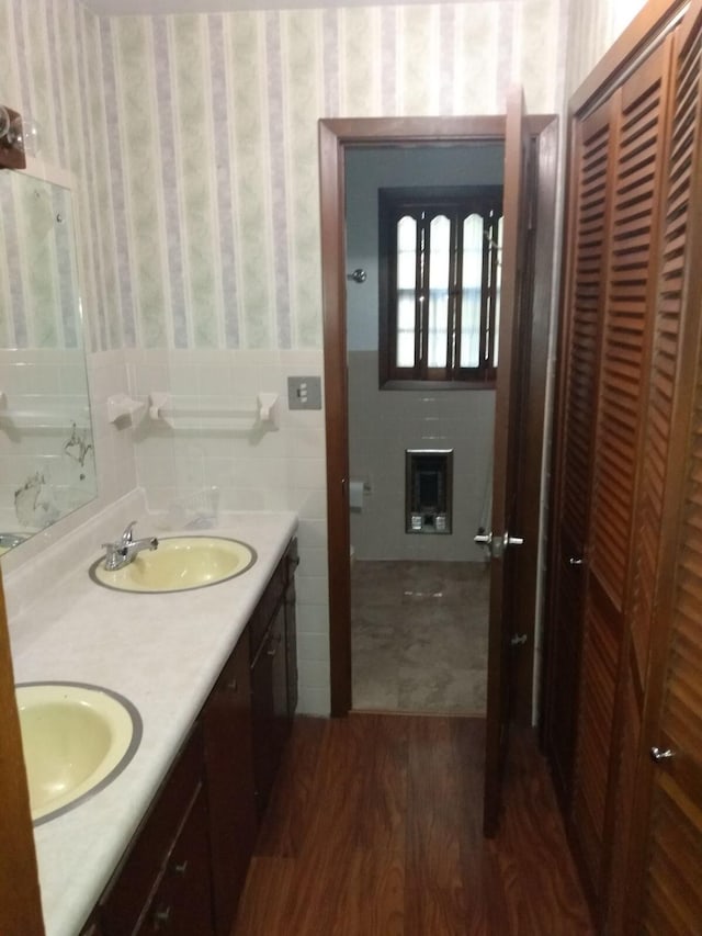 bathroom featuring vanity, hardwood / wood-style floors, and tile walls