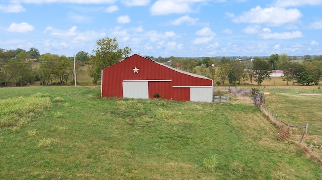 view of outbuilding with a yard and a rural view