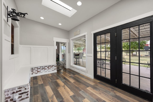 interior space featuring dark wood-type flooring and a skylight