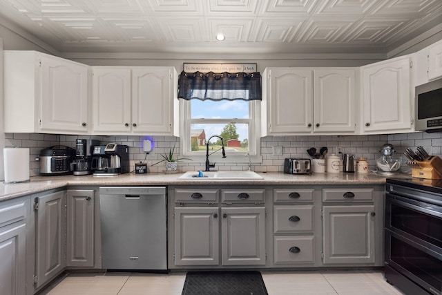 kitchen featuring sink, gray cabinets, appliances with stainless steel finishes, and white cabinetry