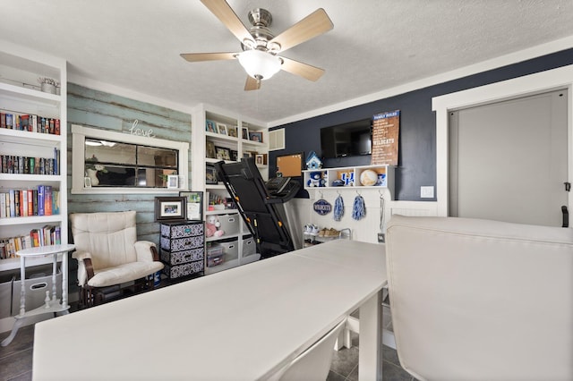 office space featuring ceiling fan and a textured ceiling