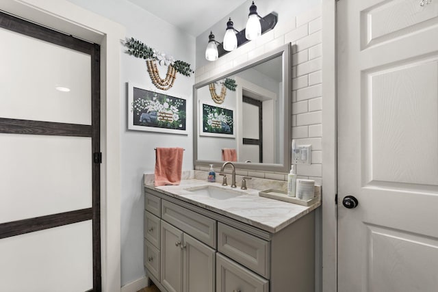 bathroom featuring tasteful backsplash and vanity