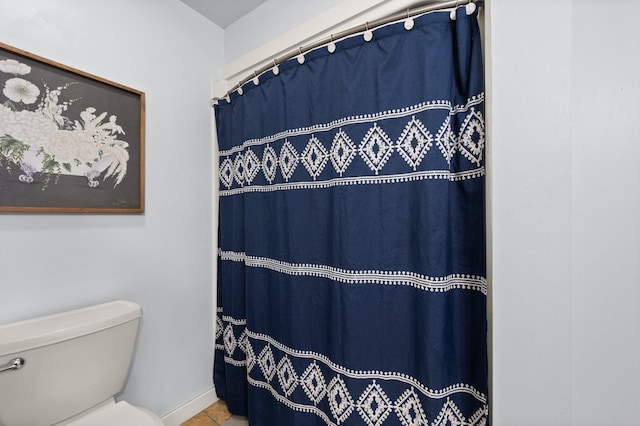 bathroom featuring toilet and tile patterned flooring