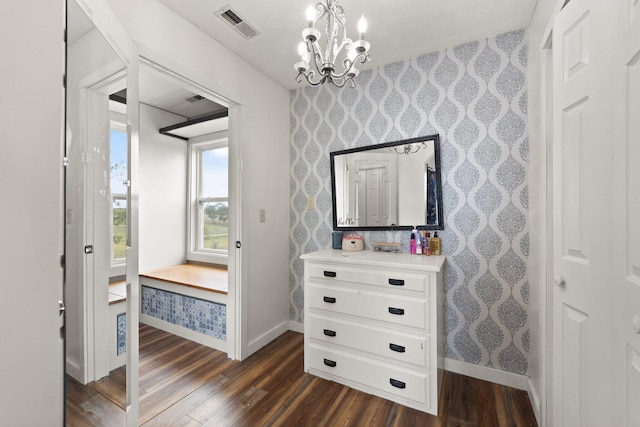 bedroom with an inviting chandelier and dark hardwood / wood-style flooring