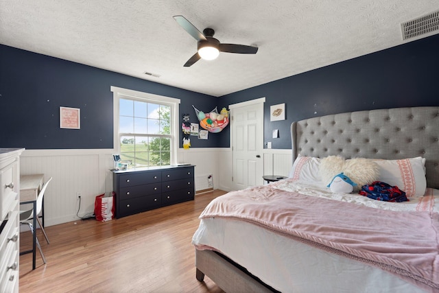 bedroom featuring a textured ceiling, hardwood / wood-style floors, and ceiling fan