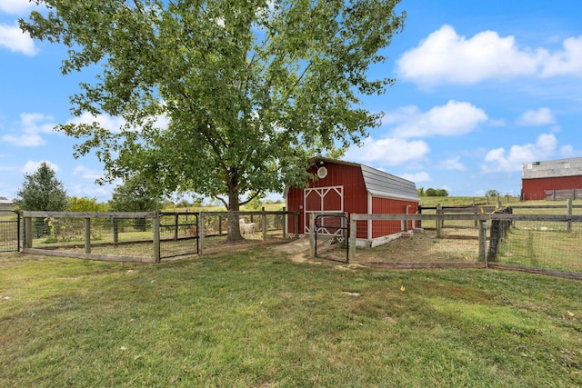 view of yard featuring an outbuilding and a rural view