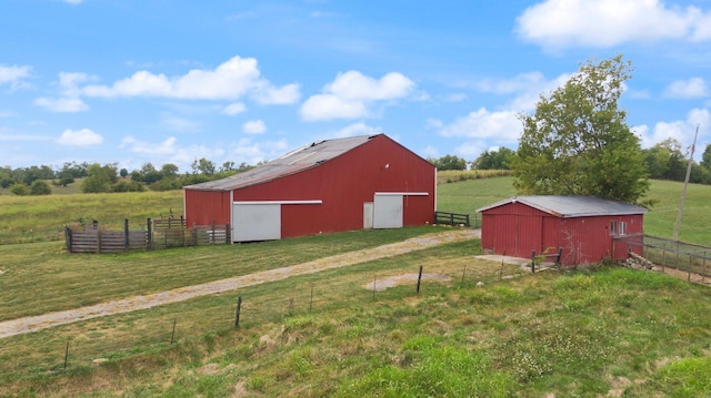 view of outdoor structure featuring a yard and a rural view