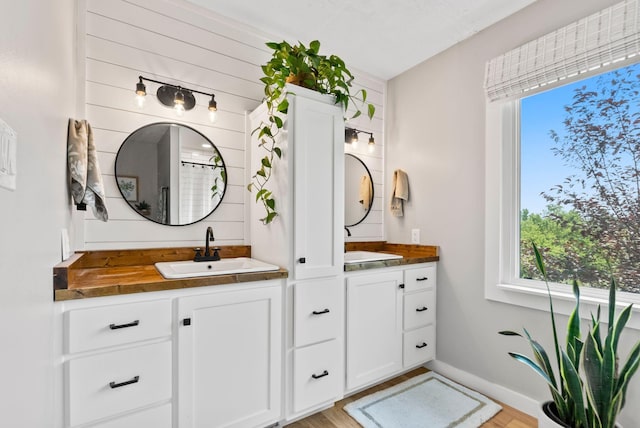 bathroom with vanity and wood-type flooring