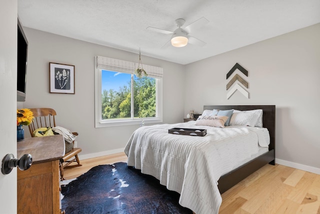 bedroom with ceiling fan and light wood-type flooring