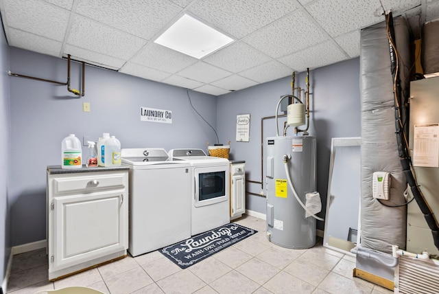 laundry room with light tile patterned flooring, water heater, cabinets, and washer and dryer