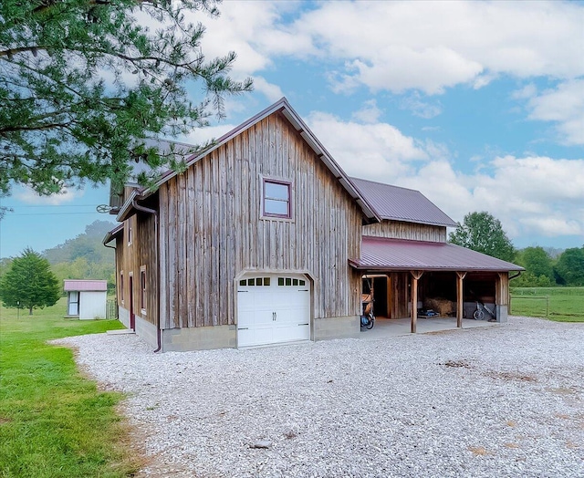 exterior space featuring an outbuilding and a garage