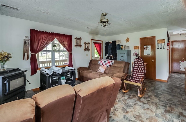 living room with ceiling fan and a textured ceiling