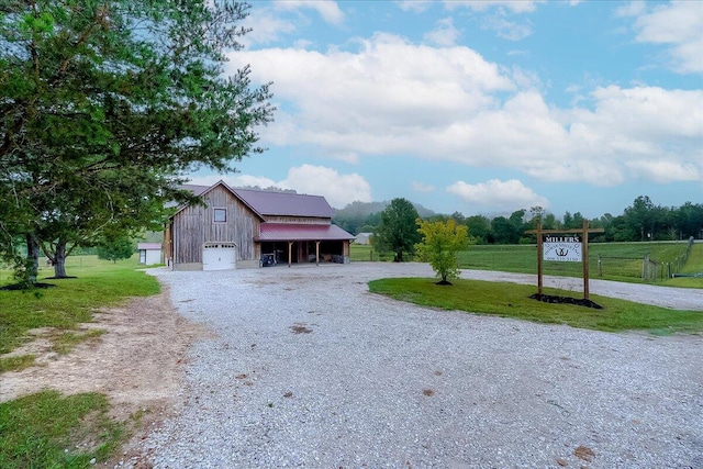 exterior space with a front yard, an outdoor structure, and a garage