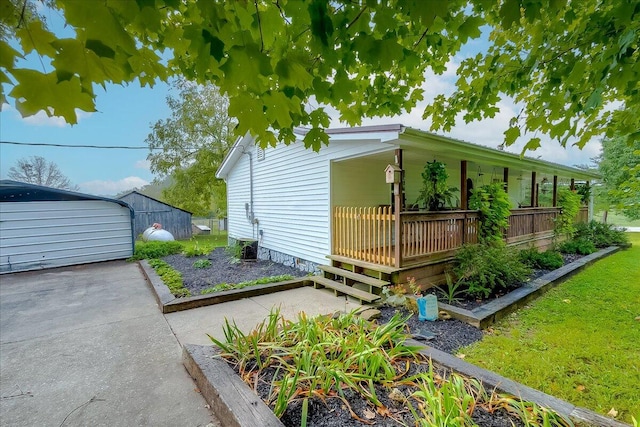 view of side of property featuring an outbuilding and a garage