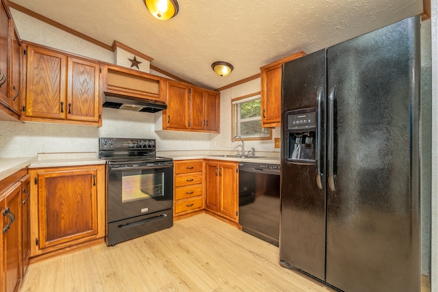 kitchen with ornamental molding, black appliances, sink, ventilation hood, and lofted ceiling