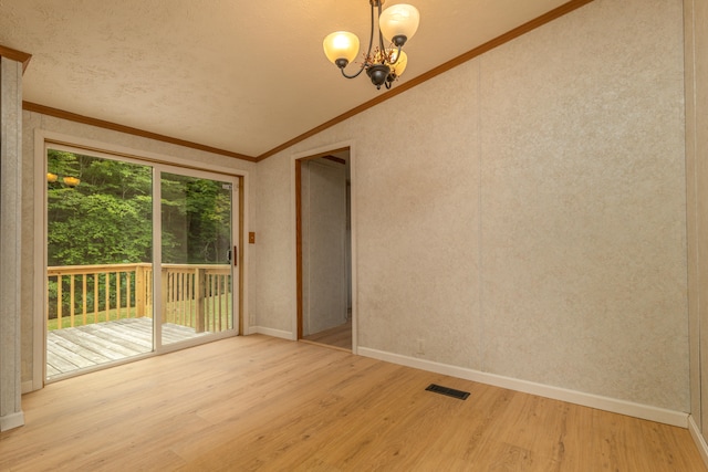 unfurnished room with light wood-type flooring, vaulted ceiling, ornamental molding, and an inviting chandelier