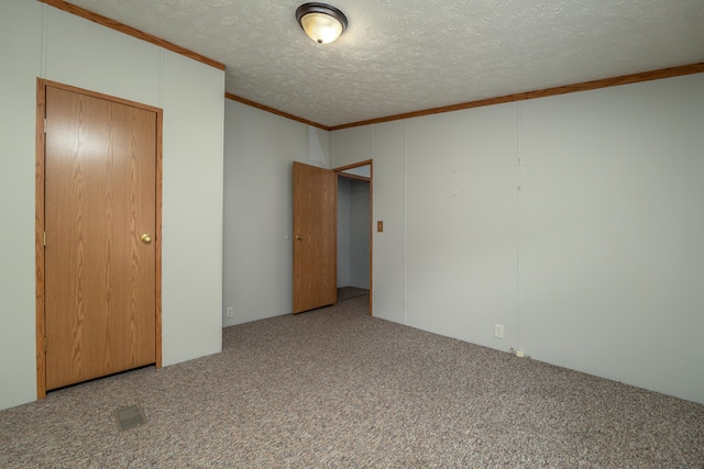 interior space with ornamental molding, a textured ceiling, and carpet floors