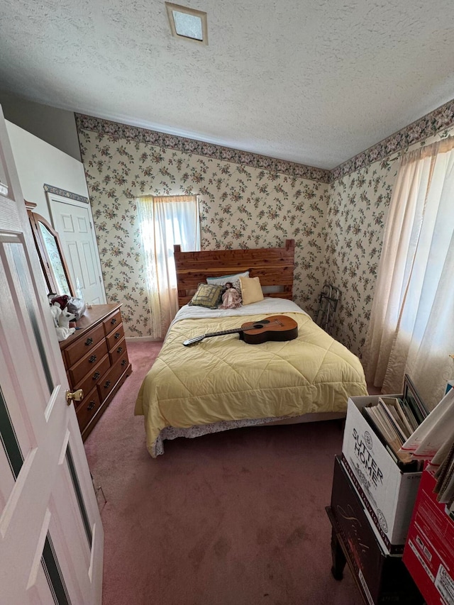 carpeted bedroom featuring a textured ceiling