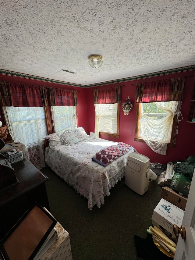 bedroom featuring a textured ceiling and carpet floors