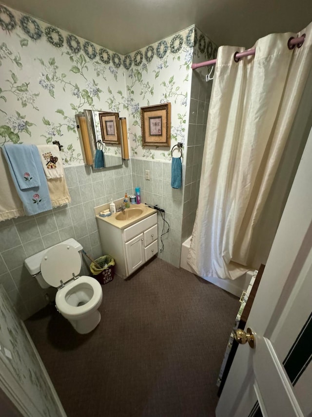 full bathroom with vanity, toilet, shower / tub combo with curtain, and tile walls