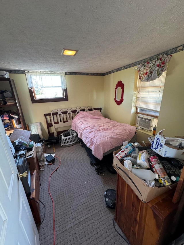 bedroom featuring a textured ceiling, cooling unit, and carpet floors