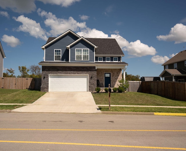 view of front of home with a garage and a front lawn