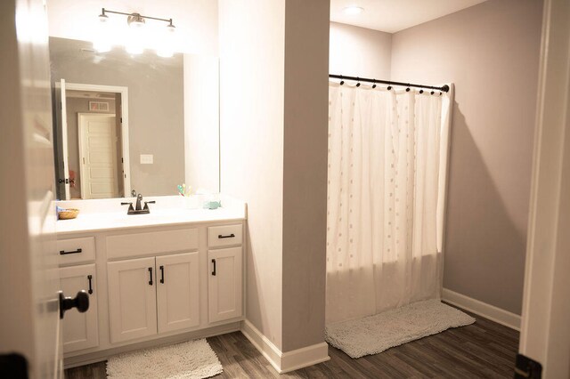 bathroom with vanity, a shower with curtain, and hardwood / wood-style floors