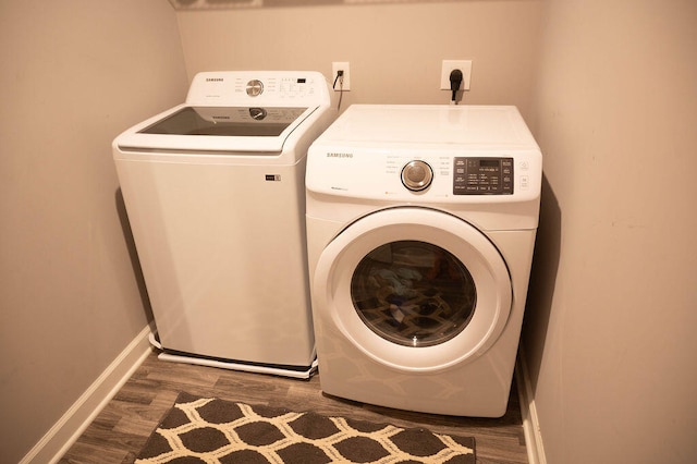 washroom featuring dark hardwood / wood-style flooring and washer and clothes dryer