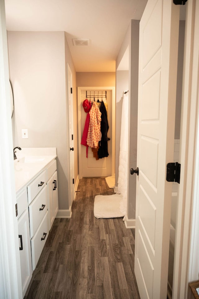 bathroom featuring hardwood / wood-style floors, a shower with shower curtain, and vanity