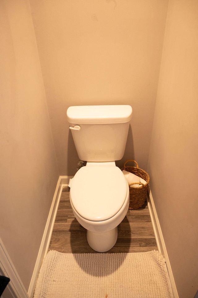 bathroom featuring wood-type flooring and toilet