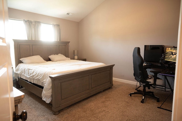 bedroom with lofted ceiling and light carpet