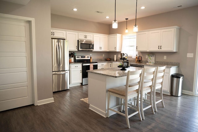 kitchen with a center island, appliances with stainless steel finishes, and white cabinetry