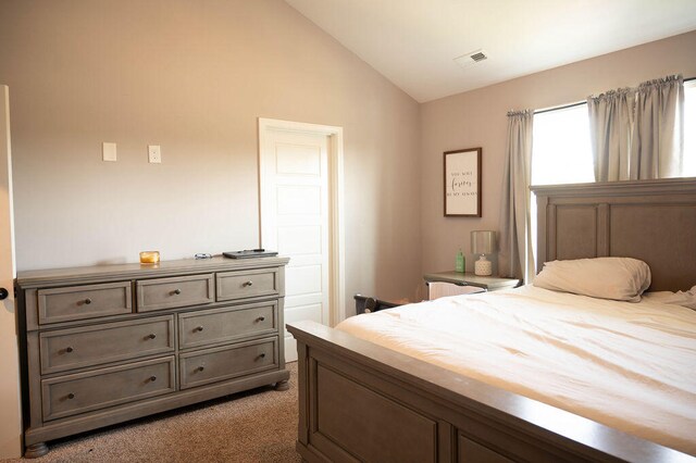 bedroom featuring lofted ceiling and dark colored carpet