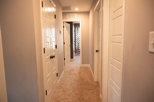 corridor with light colored carpet