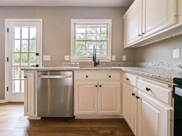 kitchen with dishwasher, dark hardwood / wood-style flooring, a healthy amount of sunlight, and light stone counters