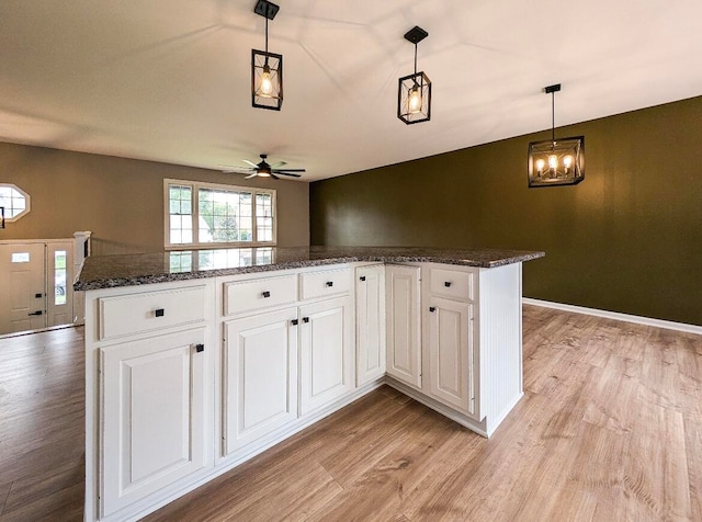 kitchen with light hardwood / wood-style flooring, pendant lighting, white cabinetry, and ceiling fan