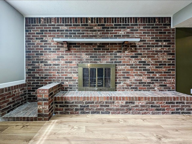 details featuring hardwood / wood-style flooring, a fireplace, and a textured ceiling