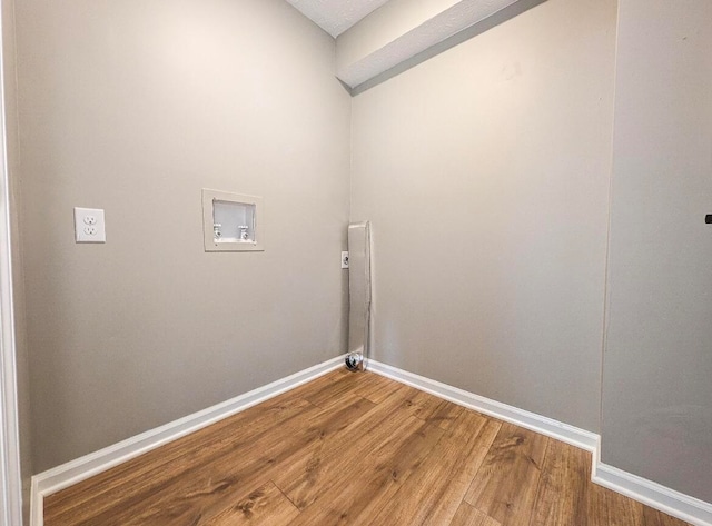 laundry room with washer hookup and hardwood / wood-style flooring