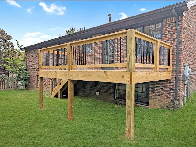 rear view of house with a lawn and a deck