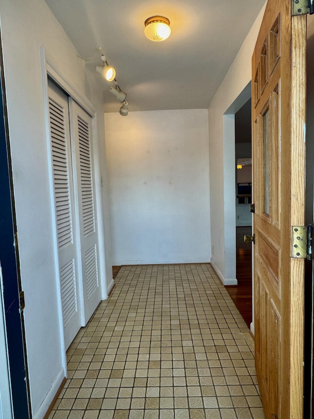 hallway with tile patterned flooring