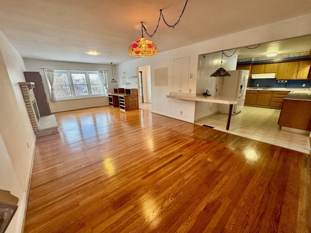 unfurnished living room with light hardwood / wood-style flooring