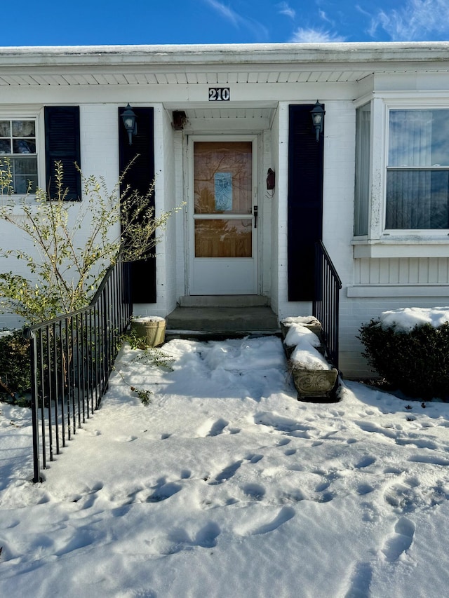 view of snow covered property entrance