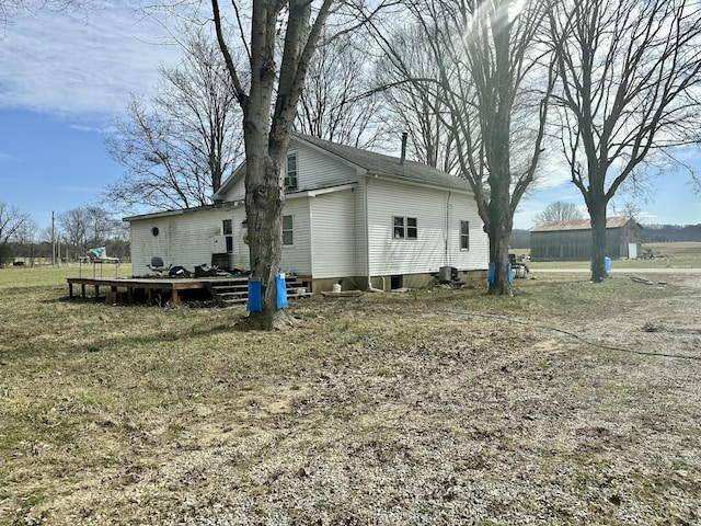 view of side of property featuring a wooden deck and central air condition unit