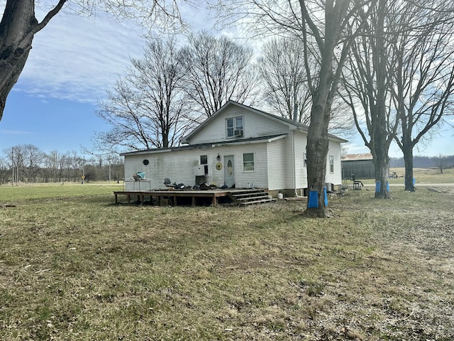 view of front facade with a front yard and a wooden deck