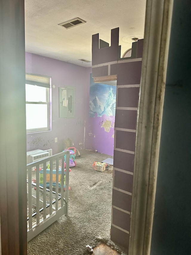 bedroom featuring a nursery area and visible vents