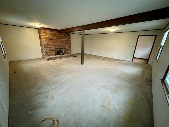 finished basement with a brick fireplace